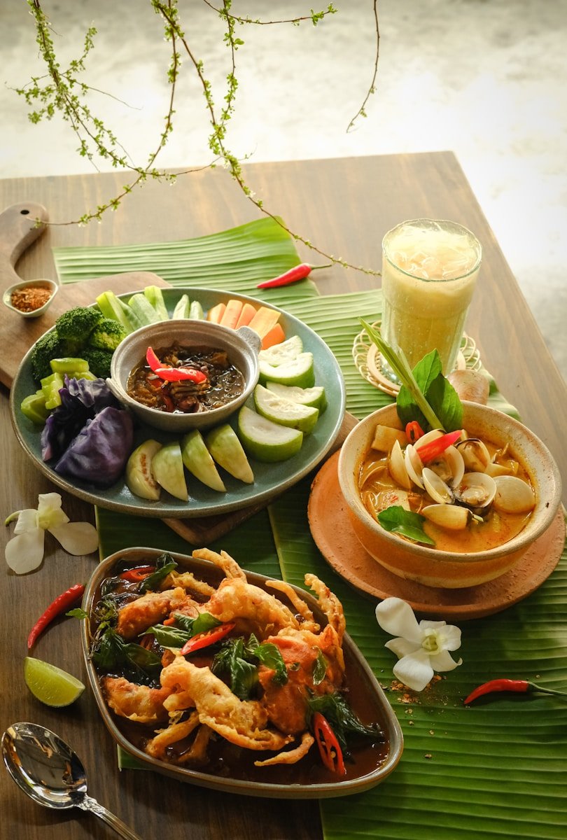 A wooden table topped with plates of food