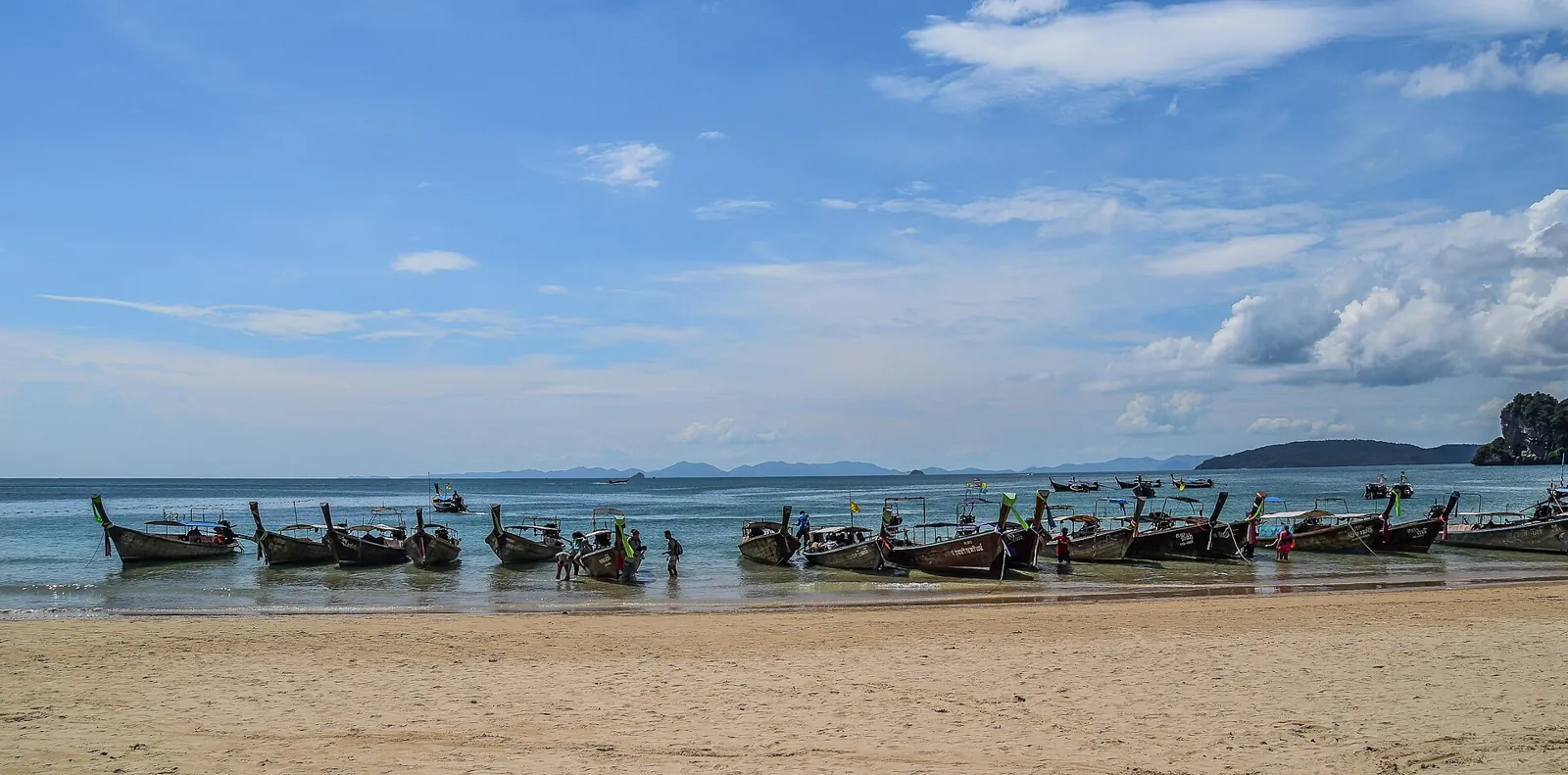 Longtail boats along West Railay Beach in Krabi.