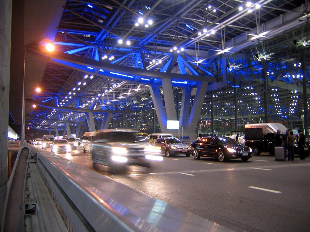 Vehicles beside Suvarnabhumi Airport terminal at night