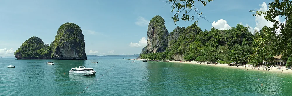 Dramatic limestone formations rise from the sea at Phra Nang Beach near Railay, Krabi.